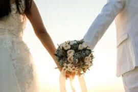 picture of a bride and a groom holding a bouquet