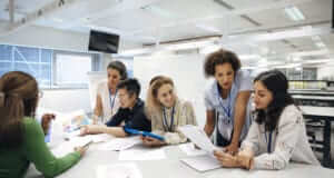 Woman teaching young adults in class setting