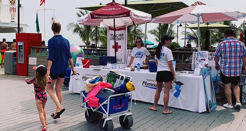 teacher week at the beach event tables, staff and beach goers on the boardwalk in Point Pleasant