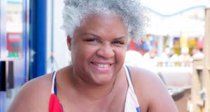 Close up of African American woman with short gray hair smiling outdoors in the summer