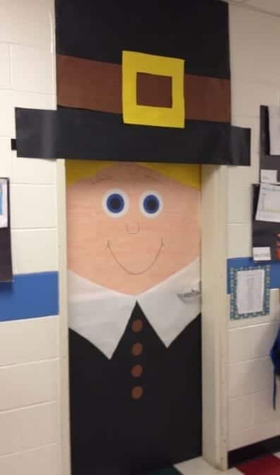 Classroom door decorated as a girl pilgrim with blonde hair and a hat