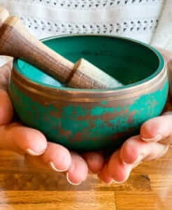 Hands holding a singing bowl