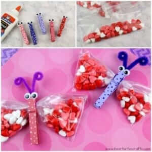 Butterflies made out of clothespins, googly eyes, pipe cleaners, snack bags, and candy hearts