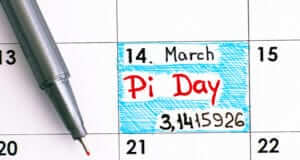 Pen and calendar with March 14th marked as Pi Day 3.1415926