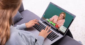 A female student on her laptop participating in virtual learning