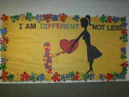 A bulletin board that says "I am different, not less". It has a yellow background. The boarder is multi-colored puzzle pieces. In the center is the shadow of a woman and child both touching a red heart