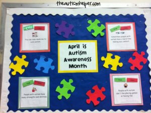 A bulletin board that says "April is autism awareness month and 4 true or false statements. 1. You can take medicine to cure autism. 2. Sometimes people with autism have a hard time making eye contact. 3. People with autism have many strengths and abilities. 4. People with autism don't like playing games or having fun. The background of the bulletin board is blue and there are multi-colored puzzle pieces as decoration.