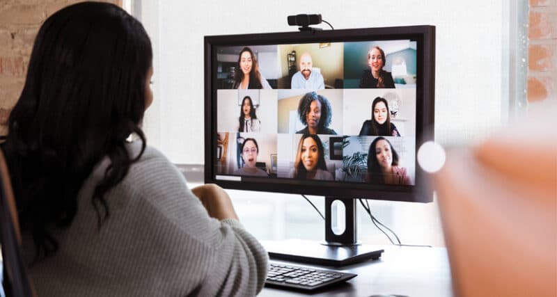 Female participating in a virtual meeting on a desktop computer